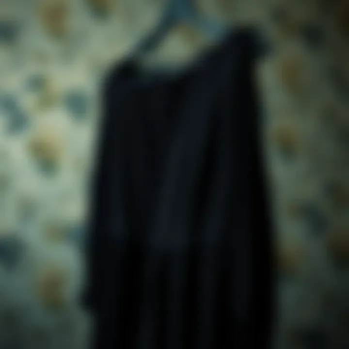 Timeless Elegance in Black Elegant black dress hanging on a vintage hanger