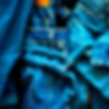 Different cuts and textures of blue denim trousers displayed together.