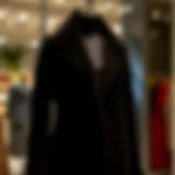 Elegant black coat displayed on a mannequin